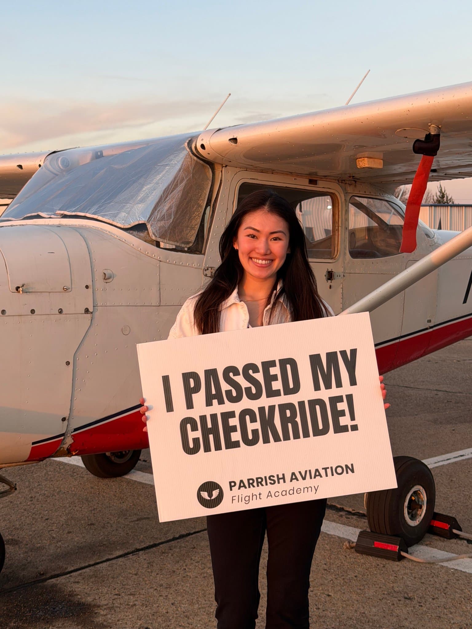 Parrish Aviation student celebrating passing her checkride